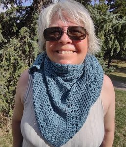 Wearing a shawl as a scarf.